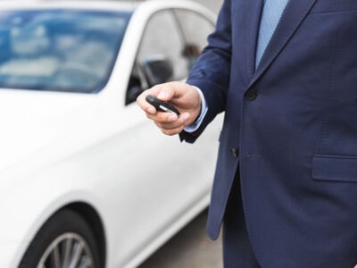 defective door lock actuator, man holding a car key fob