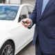 defective door lock actuator, man holding a car key fob