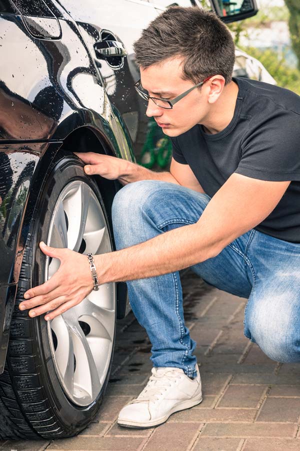 used car, man checking tire